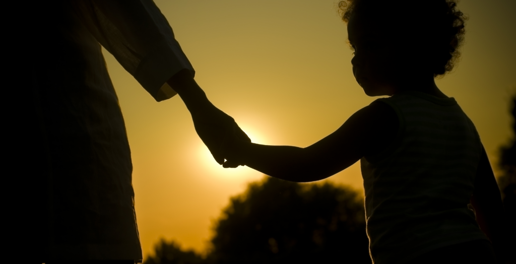 Adult holding holds with a child